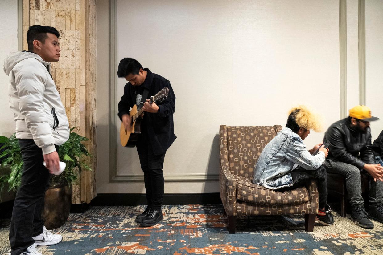 Manish Humagain, second from left, from New Hampshire, warms up Saturday prior to auditioning for "Mero Voice Universe," a Nepali musical reality show, Crowne Plaza Columbus North-Worthington. His friend Anand Rai, left, from California, also is auditioning.