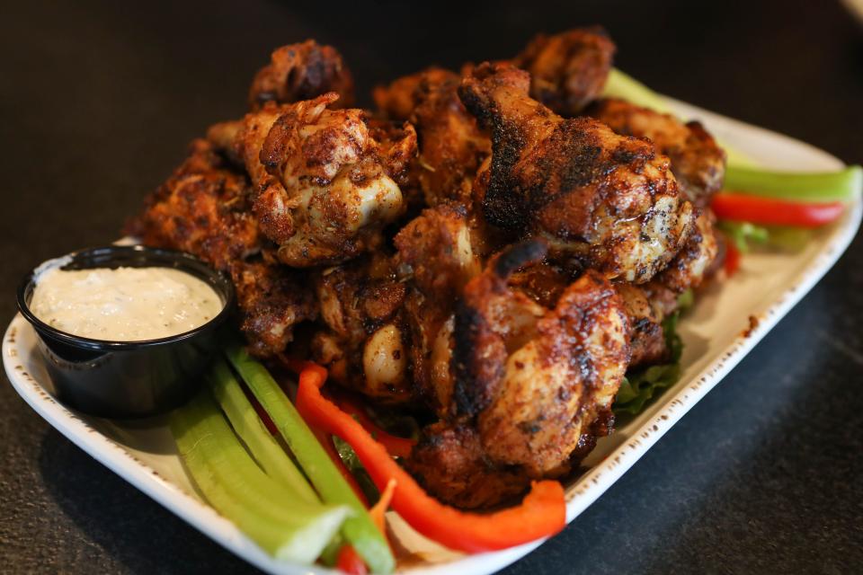 A plate of dry rub chicken wings sits on the bar at Anthony's Coal Fired Pizza restaurant in Wilmington on Thursday, Jan. 2, 2020.