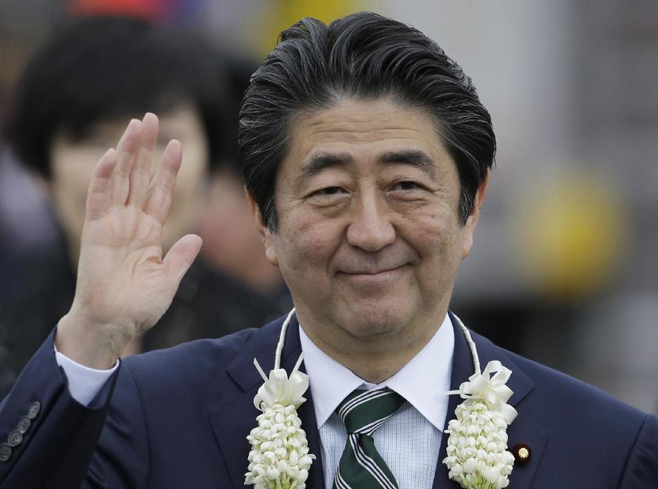 Japanese Prime Minister Shinzo Abe waves as he arrives at Manila airport, Philippines, Thursday, Jan. 12, 2017. Abe is in the country for a two-day official visit. (AP Photo/Aaron Favila)