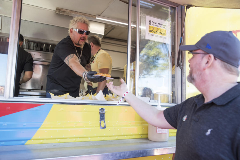 Guy Fieri passes out food at the Players Tailgate at Super Bowl LIV on Sunday, Feb. 2, 2020, in Miami. (Jeff Lewis/AP Images for The Players Tailgate)