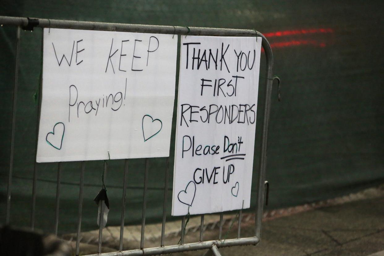 Handwritten messages of support hang on a barricade at the intersection of 88th St. and Harding Ave. near the collapsed Champlain Towers South Condo in Surfside, Fla., near Miami, on Monday, June 28, 2021.