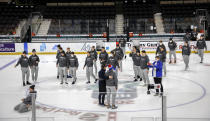 Players from the Slovakian team gather at center ice after the IIHF junior world hockey championship was cancelled in Red Deer, Alberta on Wednesday, Dec. 29, 2021. The remainder of the world junior hockey championship in Canada has been canceled over fears of a COVID-19 outbreak. The International Ice Hockey Federation made the announcement Wednesday on the recommendation of the organization’s medical officials. (Jeff McIntosh/The Canadian Press via AP)
