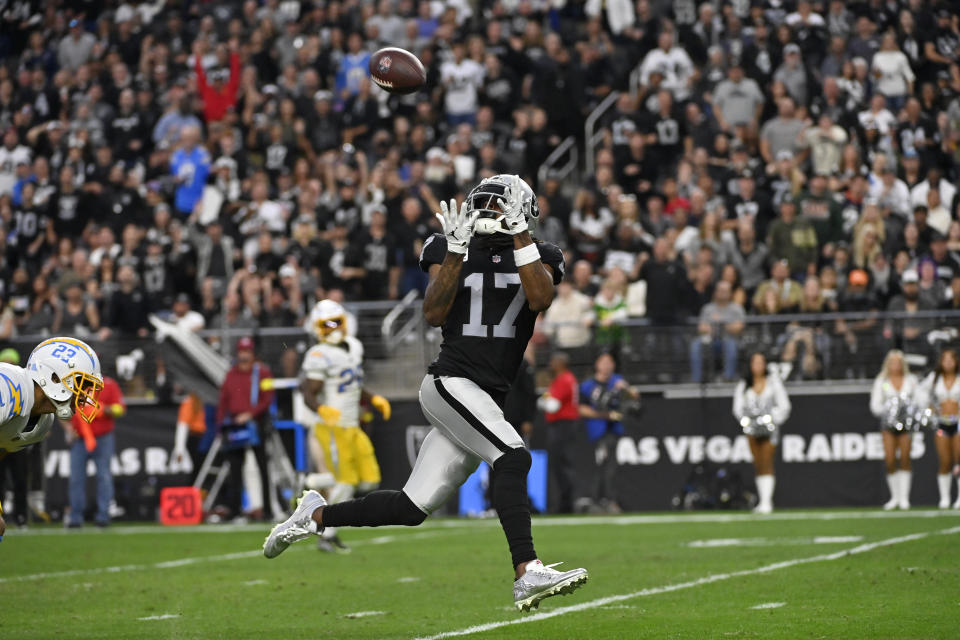 Las Vegas Raiders wide receiver Davante Adams (17) pulls in a touchdown reception during the second half of an NFL football game against the Los Angeles Chargers, Sunday, Dec. 4, 2022, in Las Vegas. (AP Photo/David Becker)