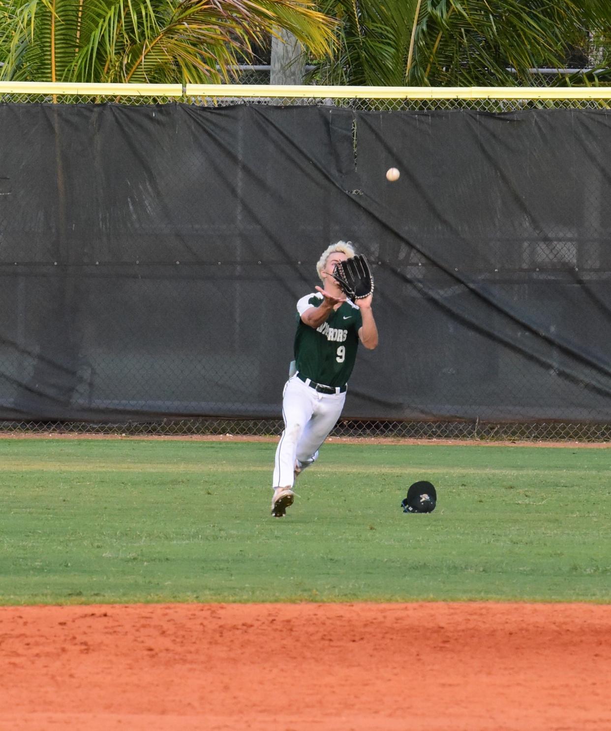 Jupiter's Gavin Marchese ranges in from center-field to make a catch on the run for the out against Benjamin on April 22, 2024.