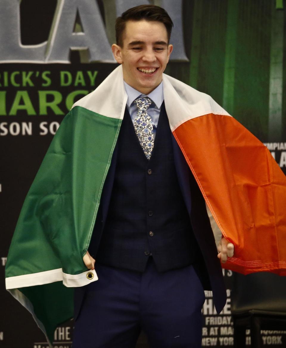 Michael Conlan, of Belfast, Northern Ireland, who boxed for Ireland at the London Olympics, wears his national flag during a press conference, Wednesday, Jan. 18, 2017, at Madison Square Garden in New York. Conlan makes his pro debut at The Garden on St. Patrick's Day, Friday March 17, in a junior featherweight bout against Denver's Tim Ibarra. (AP Photo/Bebeto Matthews)