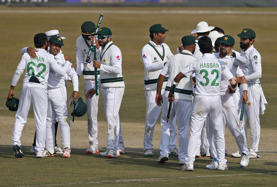 Pakistani players congratulate each others after winning the second cricket test match between Pakistan and South Africa at the Pindi Stadium in Rawalpindi, Pakistan, Monday, Feb. 8, 2021. (AP Photo/Anjum Naveed)