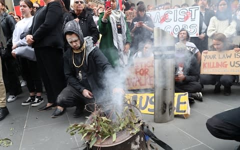 Aboriginal and Torres Strait Islanders and allies during a protest at the General Post Office in Melbourne - Credit: DAVID CROSLING/EPA-EFE/REX