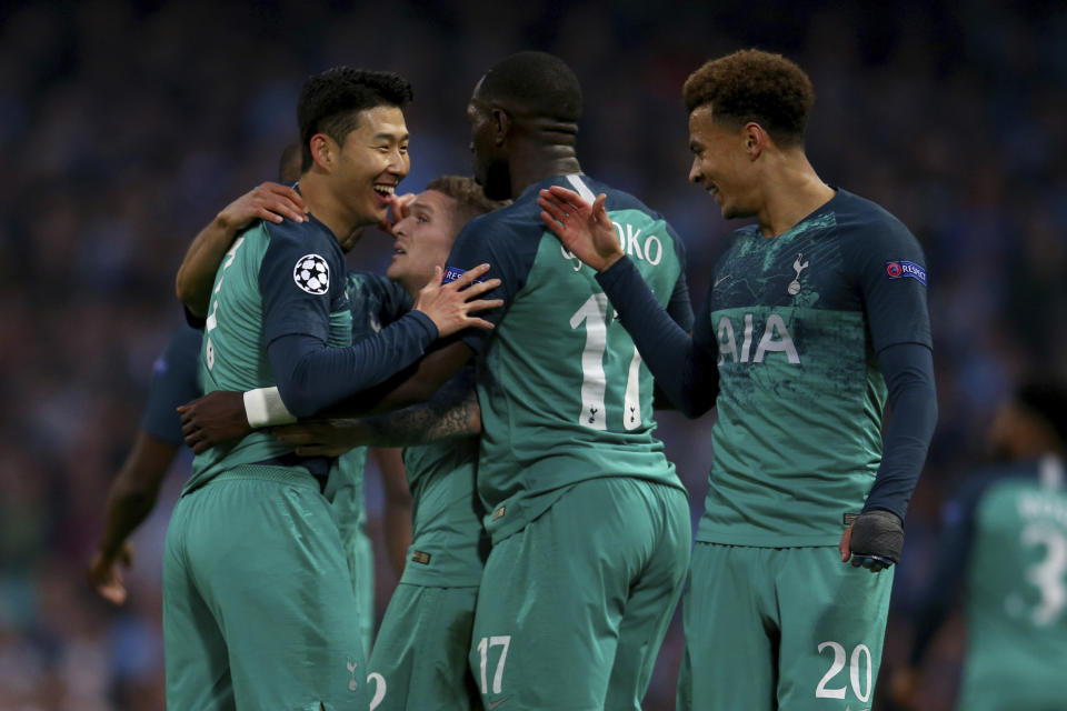 Tottenham's Son Heung-Min, left, celebrates scoring during the Champions League quarterfinal, second leg, soccer match between Manchester City and Tottenham Hotspur at the Etihad Stadium in Manchester, England, Wednesday, April 17, 2019. (AP Photo/Dave Thompson)