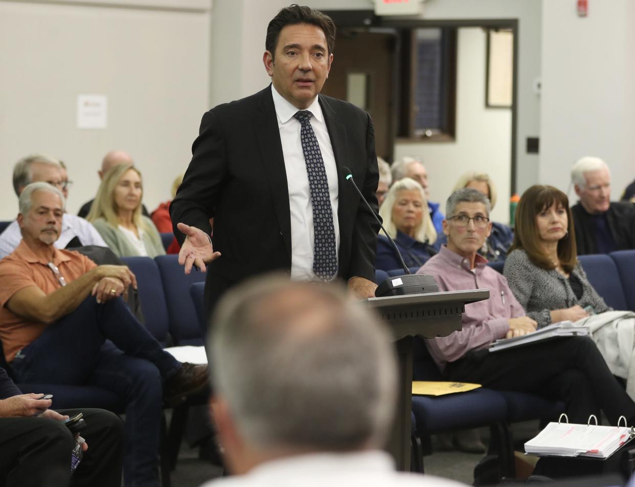 Attorney John Slagter speaks in support of the Millers Landing subdivision on North River as Jim O'Connor, Pulte's planning director, and property owner Kelley Crookston, both front row right, listen during a Stow City Council meeting.