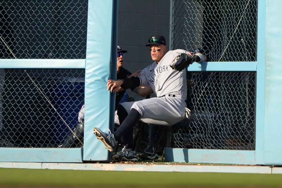 Aaron Judge catches a fly ball by Los Angeles Dodgers designated hitter J.D. Martinez in the eighth inning at Dodger Stadium on Saturday. The catch send him to the 10-day injured list with a right big toe injury.