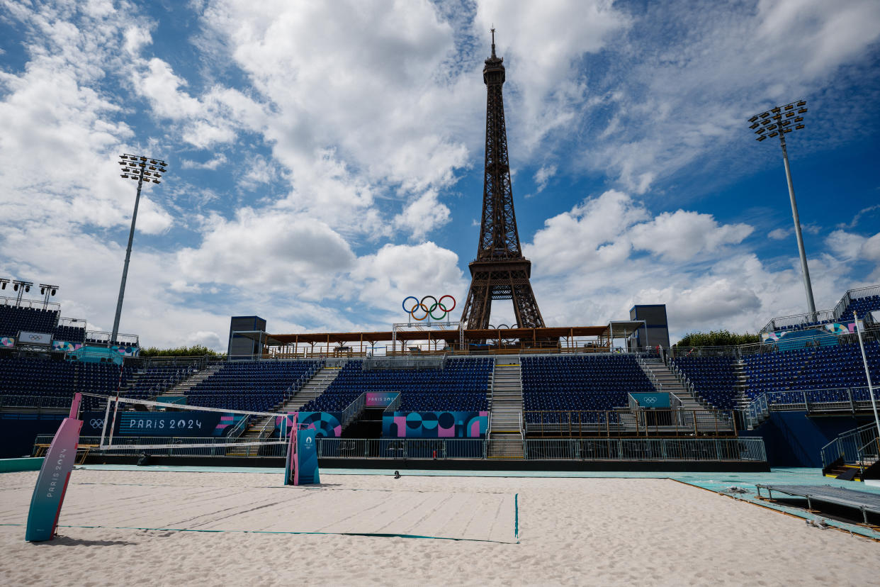 This photograph shows the Eiffel Tower behind the stands at the construction site of the Eiffel Tower Stadium for the upcoming Paris 2024 Olympics and Paralympic Games which will host the Beach Volleyball and men's Blind Football competitions, at the Champ-De-Mars in Paris on July 10, 2024. The Champ de Mars and the Trocadero, located on either side of the Eiffel Tower, will host several events of the Paris Olympic and Paralympic Games, on July 10, 2024. (Photo by Dimitar DILKOFF / AFP) (Photo by DIMITAR DILKOFF/AFP via Getty Images)