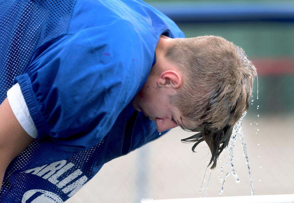 Carlinville High School's Colesen Ferratto cools down between drills during practice Friday, August 11, 2023.