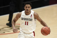 San Diego State forward Matt Mitchell (11) controls the ball during the first half of an NCAA college basketball game against Boise State Saturday, Feb 27, 2021, in San Diego. (AP Photo/Gregory Bull)