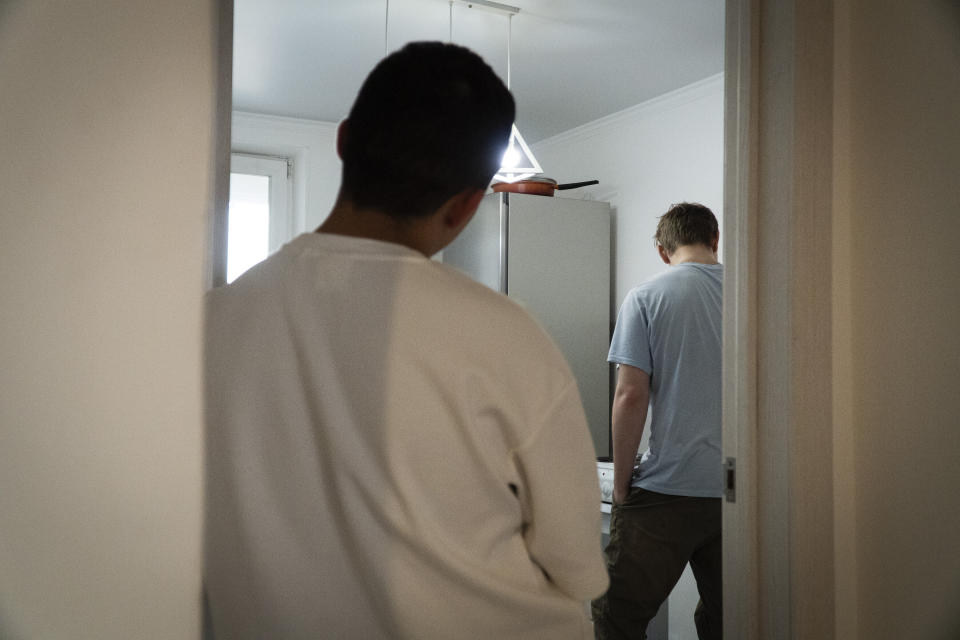 Farhad Ziganshin, a Russian officer who deserted in 2022, stands at the door of his shared room in a temporary apartment in Astana, Kazakhstan, in late 2023. "Here I am living sleeping on coats, eating I don't know what. And without any money in my pocket. It's very depressing," he said. (AP Photo)