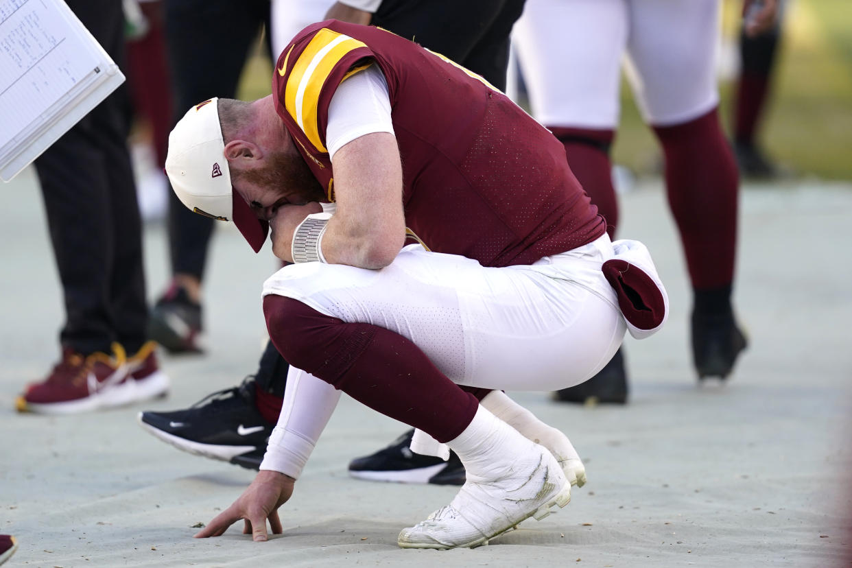 Washington Commanders quarterback Carson Wentz (11) reacts on the sideline after throwing a late interception against the Browns. (AP Photo/Patrick Semansky)