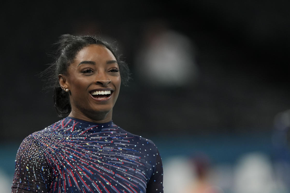 Simone Biles is on the Olympic gymnastics competition floor in front of a star-studded crowd