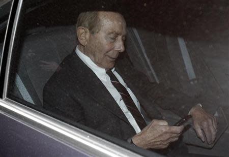 Former CEO of American International Group Inc, Maurice "Hank" Greenberg, checks his phone inside a car after leaving a building in downtown New York where he was deposed by the Attorney General's office March 10, 2010. REUTERS/Jessica Rinaldi