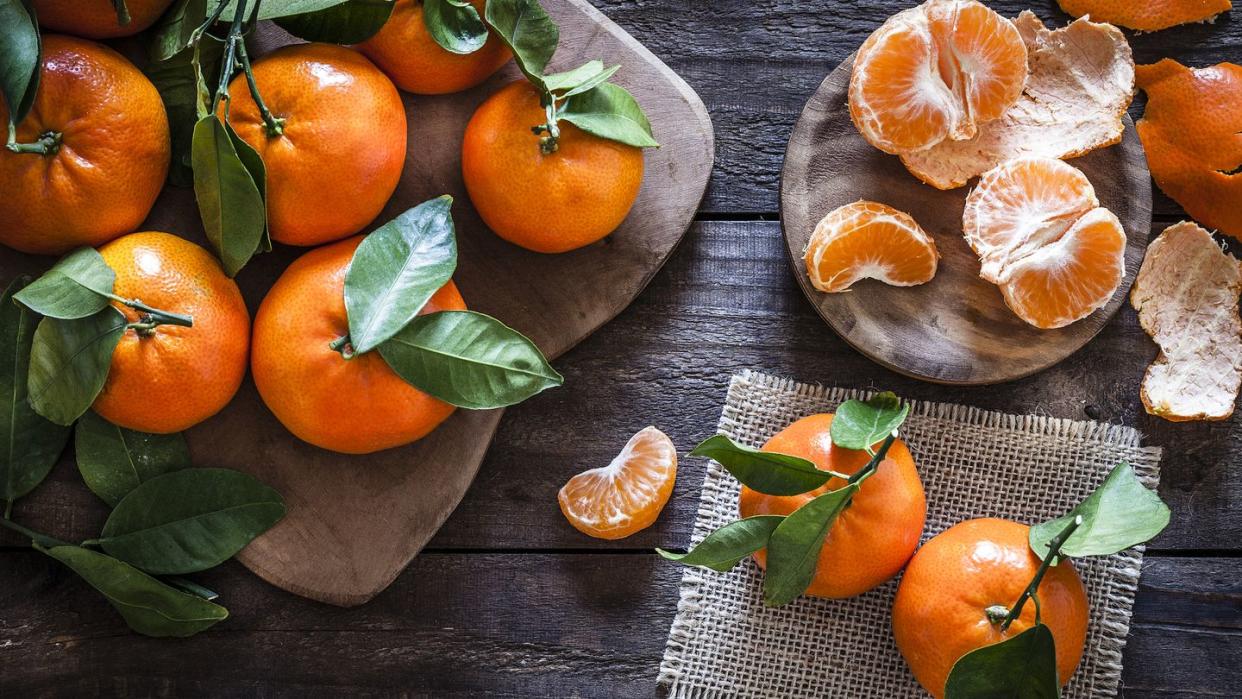 fresh organic mandarins on rustic wooden table