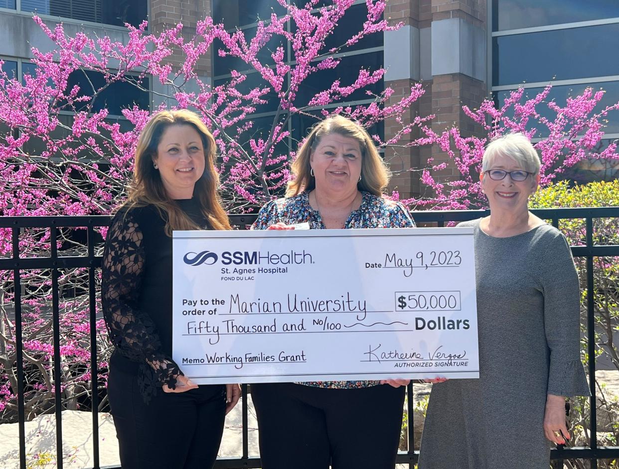 Katherine Vergos, from left, president of SSM Health St. Agnes Hospital, presents $50,000 to the Marian University Working Families Grant program to Kerry Strupp, director of the Working Families Grant and Michelle Majewski, president of Marian University.