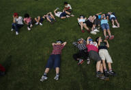 <p>School children using solar viewers lie down on a lawn as they observe an annular eclipse at Hirai Daini Elementary School in Tokyo, Japan, May 21, 2012. (Photo: Issei Kato/Reuters) </p>