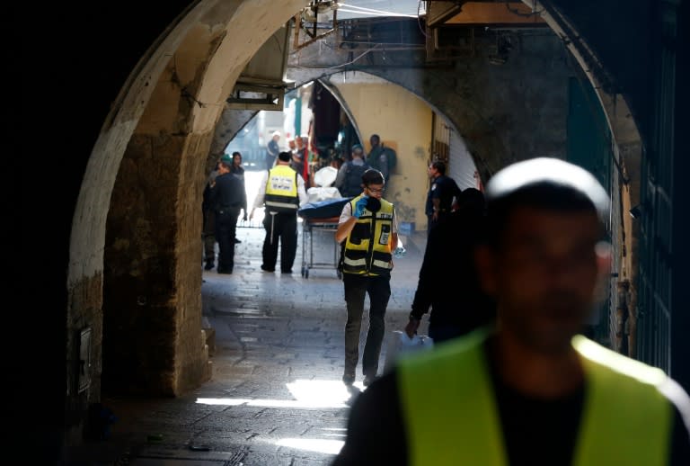 Israeli emergency personnel carry on a stretcher the covered body of a Palestinian man, who stabbed and seriously wounded an Israeli border policeman before being killed by Israeli officers, at Damascus Gate, in Jerusalem on November 29, 2015