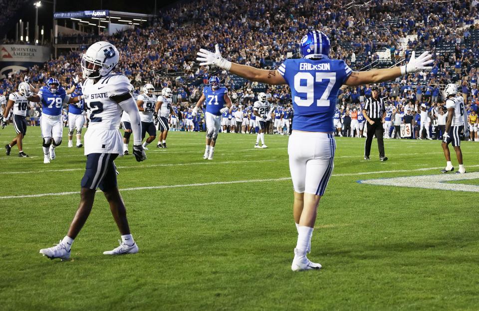 BYU tight end Ethan Erickson celebrates a touchdown against the Utah State Aggies in Provo on Thursday, Sept. 29, 2022.