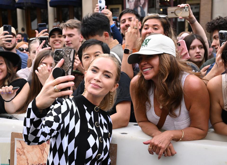 Emily Blunt takes a selfie with a fan after arriving at the premiere of her new action comedy, "The Fall Guy."