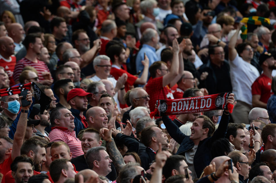 MANCHESTER, ENGLAND - SEPTEMBER 11: A Manchester Fan celebrates after Cristiano Ronaldo of Manchester United (not seen) scores his second goal during the Premier League match between Manchester United  and  Newcastle United at Old Trafford on September 11, 2021 in Manchester, England. (Photo by Serena Taylor/Newcastle United via Getty Images)