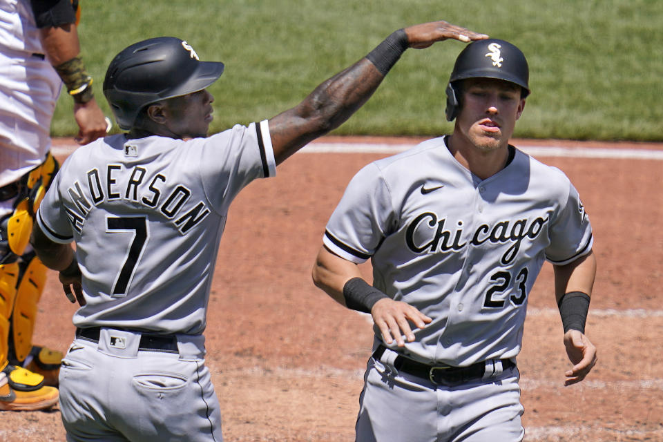 Chicago White Sox's Tim Anderson (7) and Jake Lamb celebrate after scoring on a double by Yasmani Grandal off Pittsburgh Pirates starting pitcher Chase De Jong during the fifth inning a baseball game in Pittsburgh, Wednesday, June 23, 2021. (AP Photo/Gene J. Puskar)