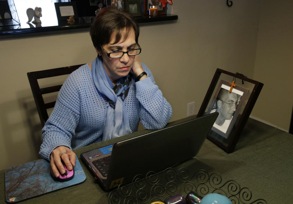 In this Monday, March 17, 2014 photograph, Patty DiRenzo looks online at her home in Blackwood, N.J., for people seeking help for drug addiction. DiRenzo, whose son, Salvatore Marchese, overdosed on heroin in 2010, says that she looks everyday for people that might need her advice. DiRenzo spent years trying to get help for her son, but was denied for many reasons. She was constantly told she didn’t meet the “criteria” for treatment centers. She even got turned away from emergency rooms because doctors say alcohol withdrawal is life threatening, but heroin withdrawal is not. (AP Photo/Mel Evans)