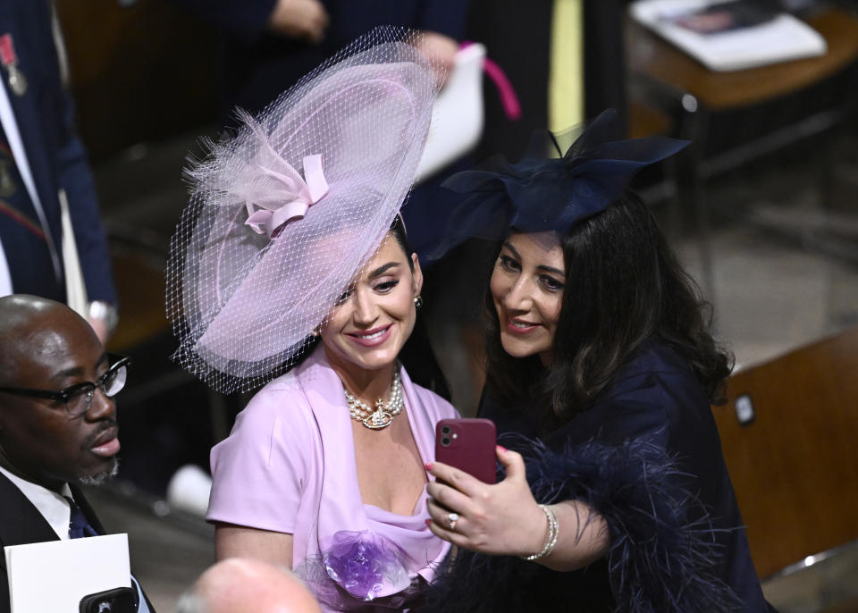 <p>LONDON, ENGLAND - MAY 06: (L-R) Edward Enninful, Katy Perry and Nadia El-Nakla take a selfie during the Coronation of King Charles III and Queen Camilla on May 06, 2023 in London, England. The Coronation of Charles III and his wife, Camilla, as King and Queen of the United Kingdom of Great Britain and Northern Ireland, and the other Commonwealth realms takes place at Westminster Abbey today. Charles acceded to the throne on 8 September 2022, upon the death of his mother, Elizabeth II. (Photo by Gareth Cattermole/Getty Images)</p> 