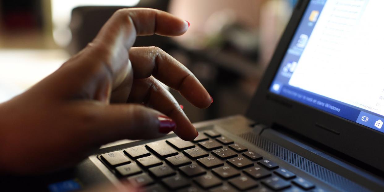 A woman uses a laptop.