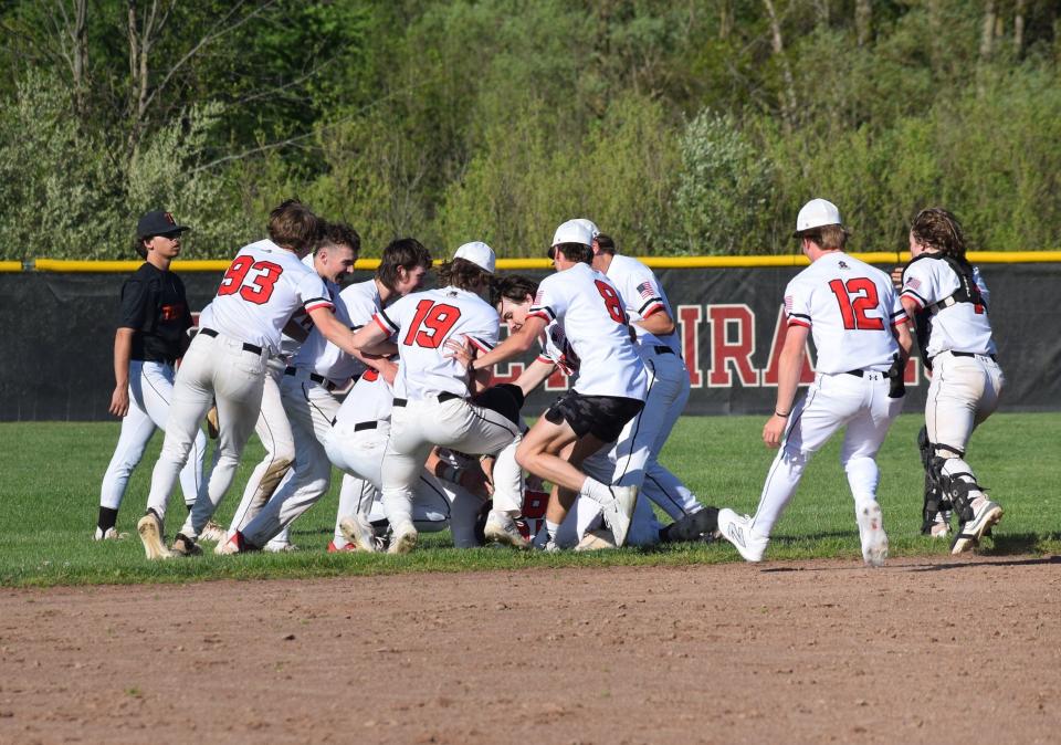 Pinckney baseball players celebrate a 4-3 walk-off victory in the ninth inning over Tecumseh Wednesday, May 8, 2024.