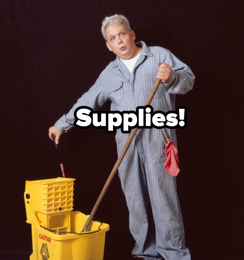 Person in a striped janitorial uniform mopping, standing beside a yellow mop bucket with a caution sign