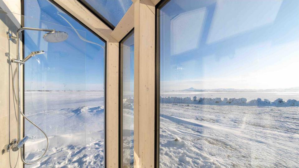 Glass house in Hella, Iceland, vast landscape views and nighttime view of Northern Lights