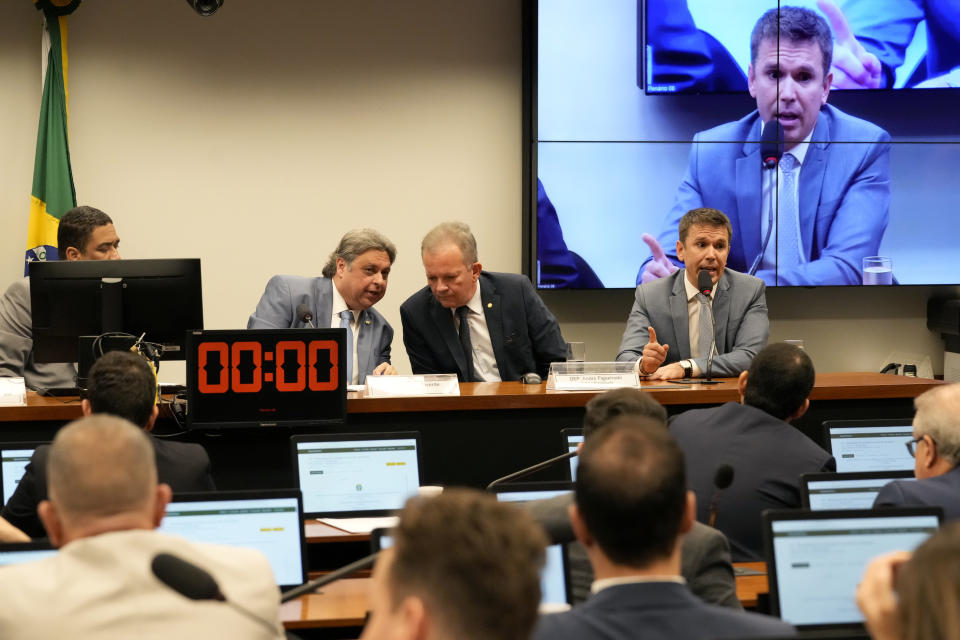 Deputy Felipe Carreras, right, commission rapporteur, speaks during the first meeting of the Parliamentary Commission of Inquiry that investigates the scandals of manipulation of football matches, at the headquarters of the Chamber of Deputies, in Brasilia, Brazil, Wednesday, May 17, 2023. Brazil's lower house of Congress opened a probe into a soccer match-fixing scandal that has rocked the sport in the South American nation. (AP Photo/Eraldo Peres)