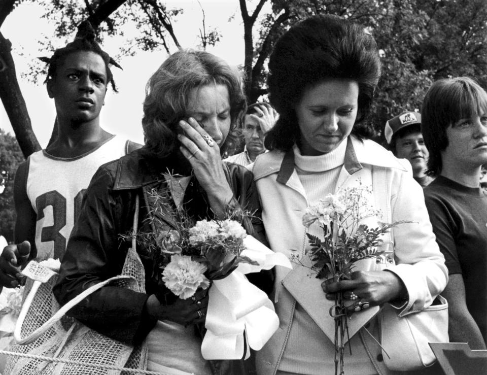 Aug. 19, 1977 - Bonnie Hutchings, left, of Rochester, N.Y., weeps with Mary Ann Thornton, of Kansas City, Kansas, at Forest Hill Cemetary Midtown. More than 50,000 fans, some of whom kept a night-long vigil at the cemetery gates, walked the last mile to pay tribute to Elvis Presley, leaving with the flowers that had lined his hillside mausoleum.