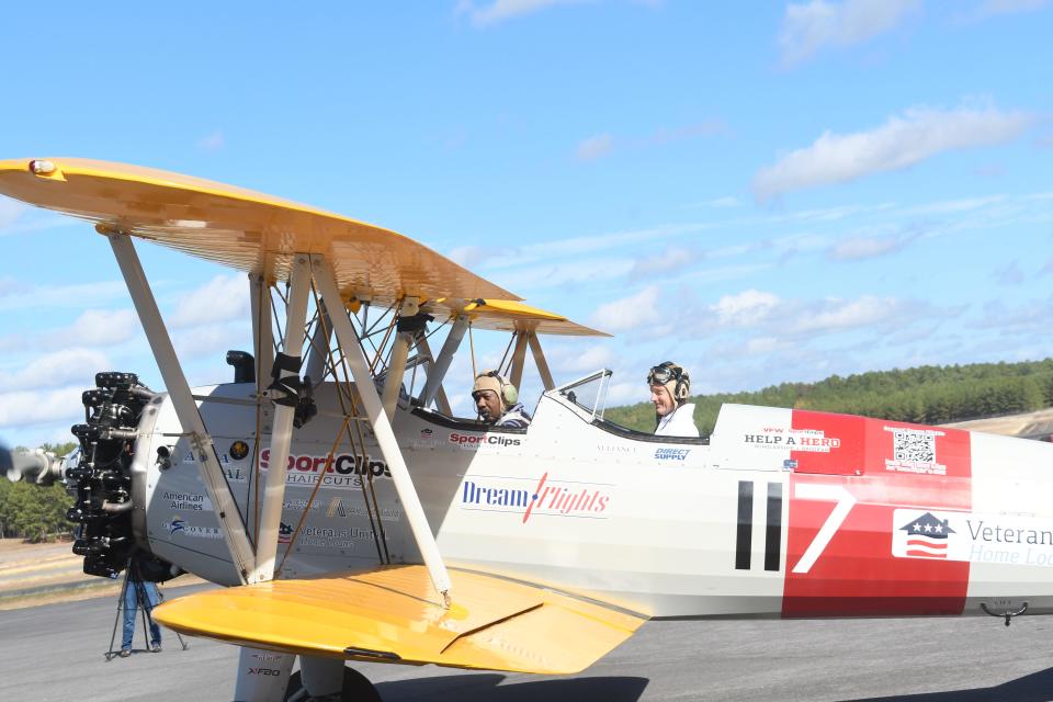 Melvin Pease (left), an Army veteran, and Dream Flights pilot James Sims return to Esler Field after their 20-minute flight.