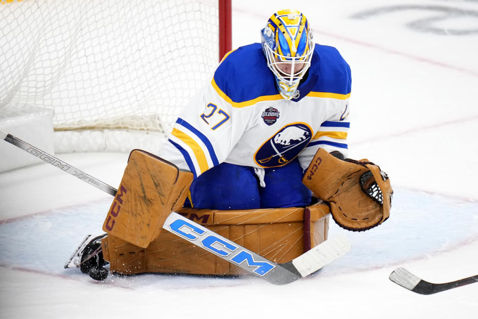 Buffalo Sabres' Devon Levi makes a save during the NHL hockey game between Buffalo Sabres and New Jersey Devils, in Prague, Czech Republic, Saturday, Oct. 5, 2024. (AP Photo/Petr David Josek)