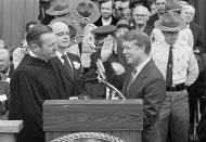 Judge Robert H. Jordan administers the oath of office to Gov. Jimmy Carter during ceremonies at the state capitol in Atlanta. Ga., Jan. 12, 1971. (AP Photo)