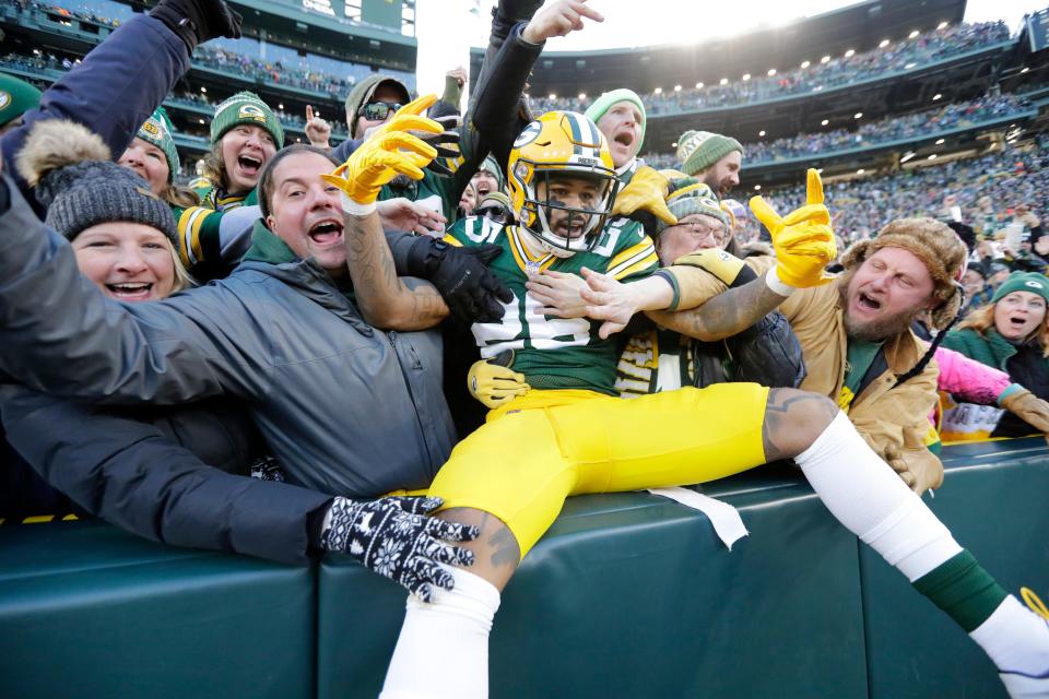 Green Bay Packers cornerback Keisean Nixon celebrates with a Lambeau Leap after returning a kick off for a touchdown during a game at Lambeau Field.
