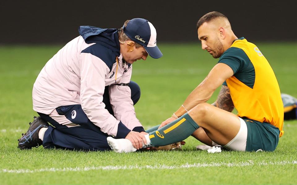 Quade Cooper of the Wallabies receives attention from the trainer  - GETTY IMAGES