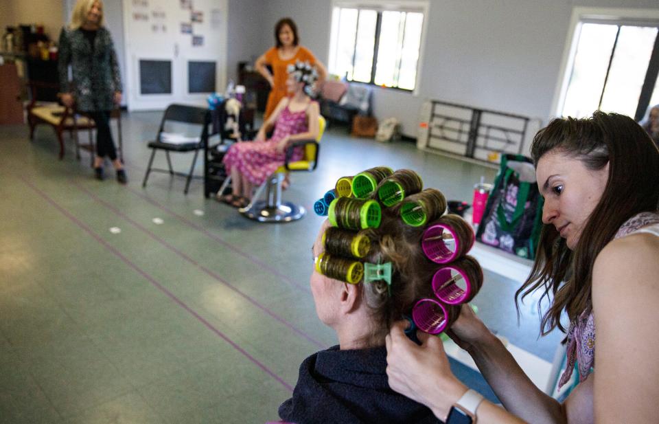Angie Janas, right, learns how to style hair during a production of Steel Magnolias on Saturday, Oct. 22, 2022 at Fleischmann Park in Naples. She was working on the hair of Beth Hylton who plays M’Lynn. Janas plays the part of Annelle. The production will take place at the Norris Community Center.