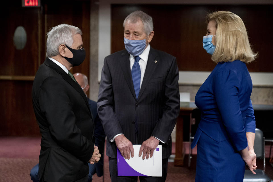 Nominee to be Secretary of the Army Christine Elizabeth Wormuth, right, speaks with Chairman Sen. Jack Reed, D-R.I., left, and former Secretary of Defense Chuck Hagel, center, before a Senate Armed Services Committee nomination hearing on Capitol Hill in Washington, Thursday, May 13, 2021. (AP Photo/Andrew Harnik)