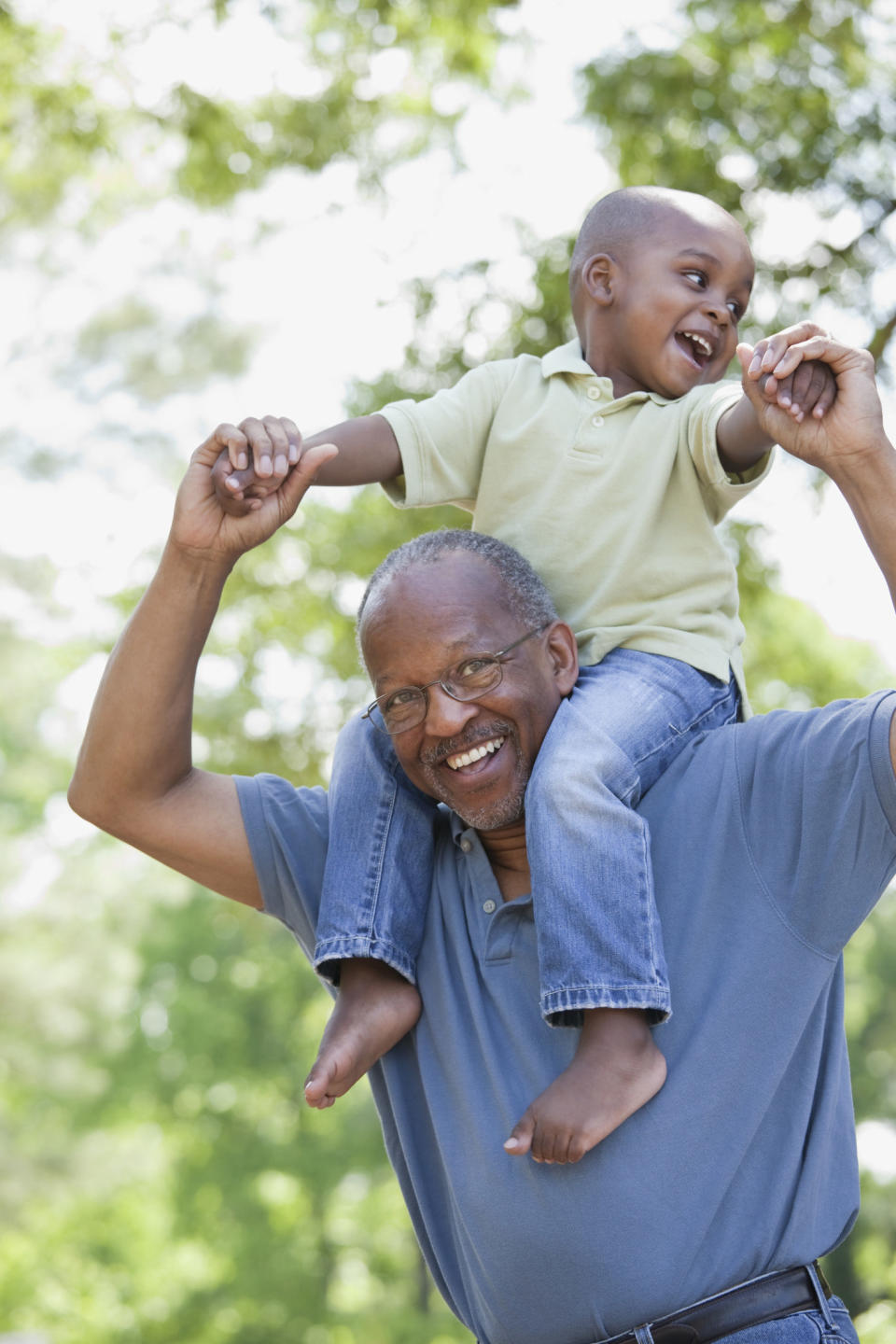 A grandfather smiling while playing with his grandson