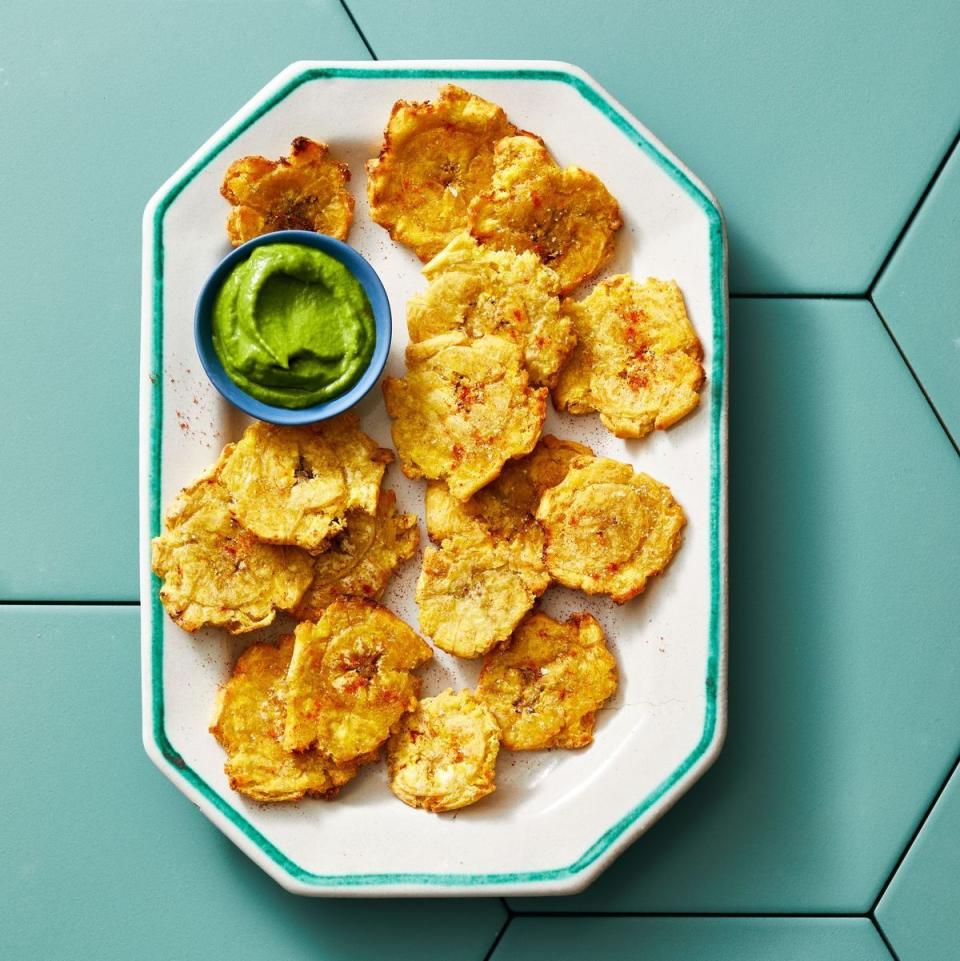 <p>Whip up tostones in no time when using the air fryer! Don't forget to make this vibrant cilantro dip that pairs perfectly.</p><p>Get the <strong><a href="https://www.goodhousekeeping.com/food-recipes/a42297027/air-fryer-tostones-with-cilantro-dip-recipe/" rel="nofollow noopener" target="_blank" data-ylk="slk:Air Fryer Tostones with Cilantro Dip recipe;elm:context_link;itc:0;sec:content-canvas" class="link ">Air Fryer Tostones with Cilantro Dip recipe</a></strong>.</p>