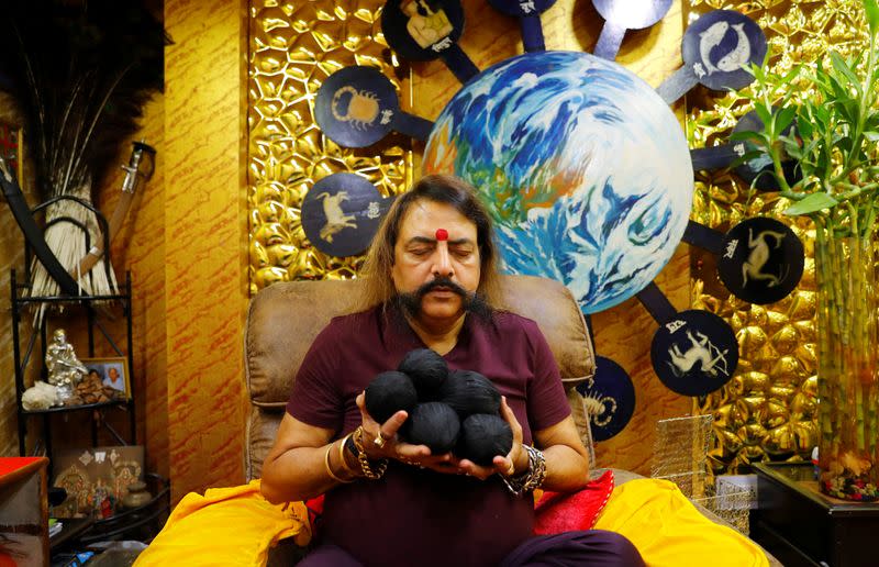 Sanjay Sharma, a mystic healer and astrologer, making prayers at his office, amidst the spread of the coronavirus disease (COVID-19), in New Delhi