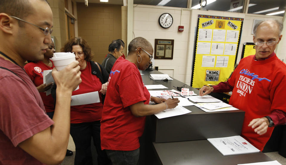 Members of the Chicago Teachers Union cast their ballots during a strike authorization vote at a Chicago high school Wednesday, June 6, 2012. Chicago Teachers Union President Karen Lewis says union members don't want to disrupt the start of the next school year with a strike, but she says they feel voting to authorize one is needed to negotiate a better contract. (AP Photo/M. Spencer Green)