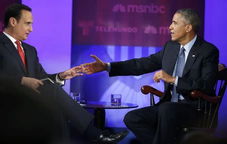 U.S. President Barack Obama (R) participates in the taping of an MSNBC/Telemundo town hall discussion on immigration with host Jose Diaz-Balart (L) at Florida International University in Miami, February 25, 2015. REUTERS/Jonathan Ernst