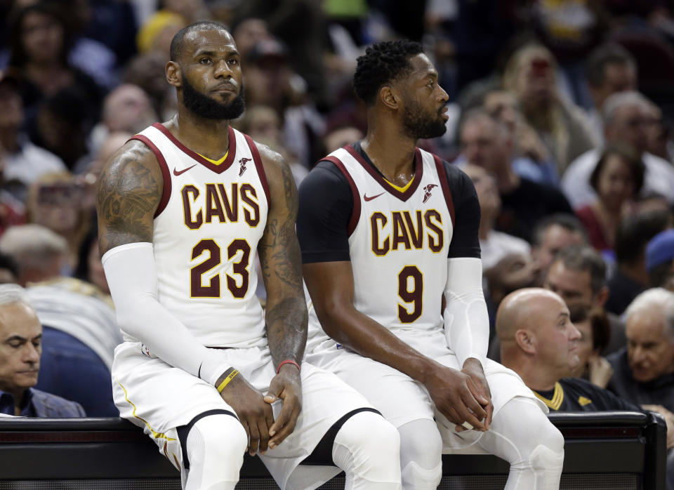 Dwyane Wade (9) takes a seat next to some guy who apparently plays in the NBA. (AP)